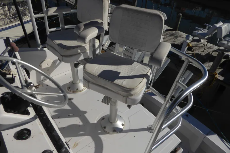 Slide: The Image of 1996 Luhrs 320 Tournament boat helm with dual captain chairs and steering wheel. - 7