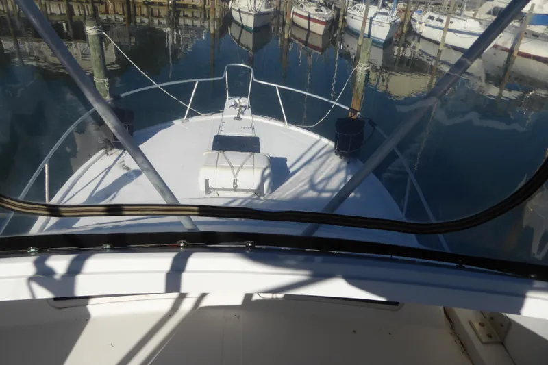 Slide: The Image of 1996 Luhrs 320 Tournament boat docked in a marina, view from the helm. - 8