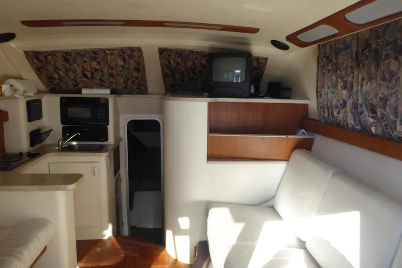Slide: The Image of Interior of 1996 Luhrs 320 Tournament boat with kitchenette, seating, and TV. - 9