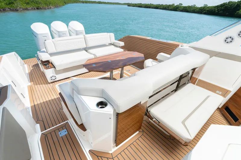 Slide: The Image of Manufacturer Provided Image: 2025 Tiara Yachts 48 LS luxury deck with seating, table, and ocean view. - 11