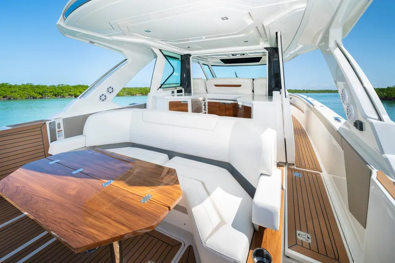 Slide: The Image of Manufacturer Provided Image: Luxurious 2025 Tiara Yachts 48 LS interior with elegant seating and wooden table. - 14