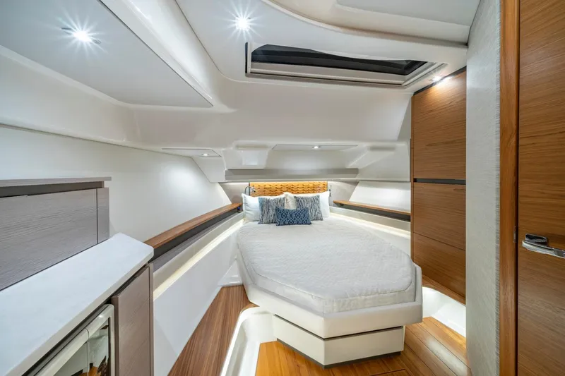 Slide: The Image of Manufacturer Provided Image: Luxurious cabin interior of 2025 Tiara Yachts 48 LS with modern design and cozy bedding. - 16