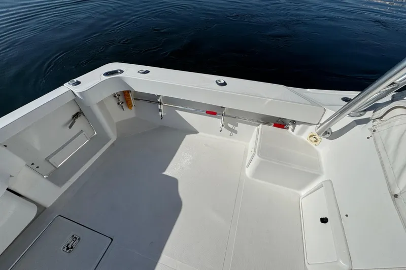 Slide: The Image of 2002 Luhrs 32 Open boat deck with clean white surface and storage compartments. - 10