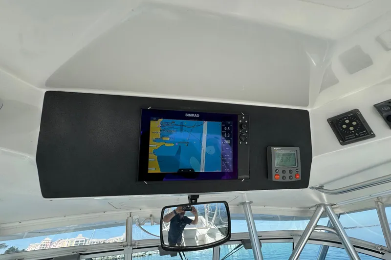 Slide: The Image of 2002 Luhrs 32 Open boat dashboard with navigation equipment and digital displays. - 15