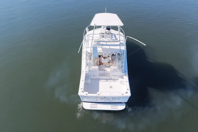 Slide: The Image of 2002 Luhrs 32 Open boat on calm water, aerial rear view. - 4