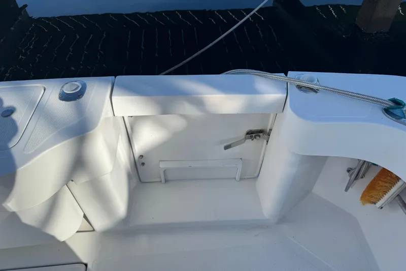 Slide: The Image of 2002 Luhrs 32 Open boat deck with storage compartment and cleaning brush. - 8