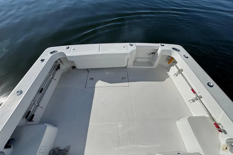 Slide: The Image of 2002 Luhrs 32 Open boat deck with fishing rod holders, on calm water. - 9