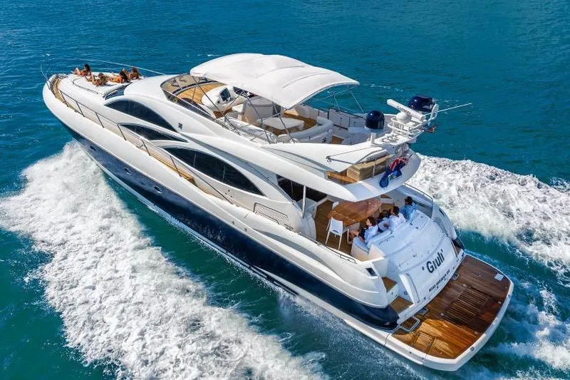 The Image of Luxurious 2000 Sunseeker Manhattan 74 yacht cruising on clear blue waters. - 1