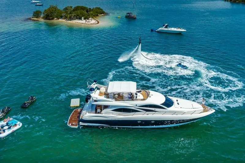 Slide: The Image of Sunseeker Manhattan 74 yacht cruising near island with water sports activities, 2000 model. - 13