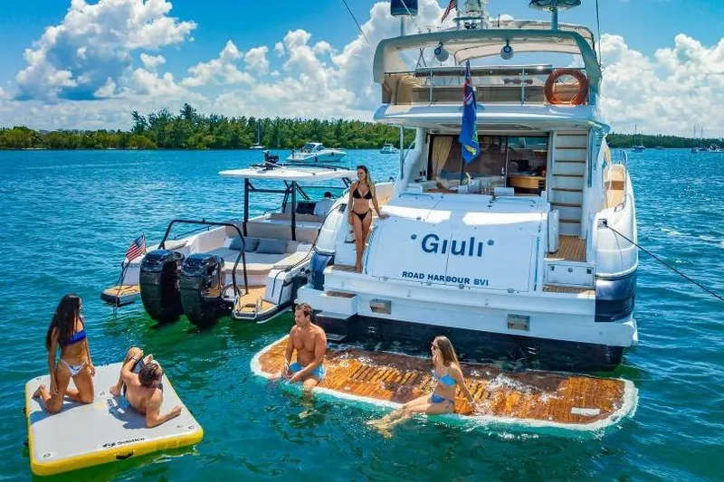 Slide: The Image of People enjoying water activities near a 2000 Sunseeker Manhattan 74 yacht. - 14