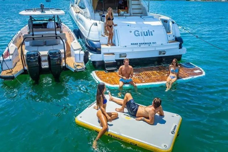 Slide: The Image of People enjoying water activities near a 2000 Sunseeker Manhattan 74 yacht. - 16