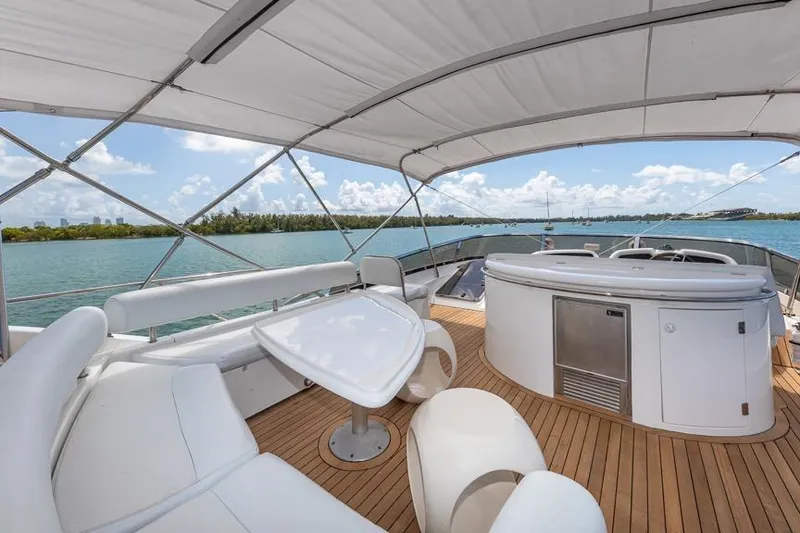 Slide: The Image of Luxurious Sunseeker Manhattan 74 yacht deck with seating, table, and ocean view, year 2000 model. - 24