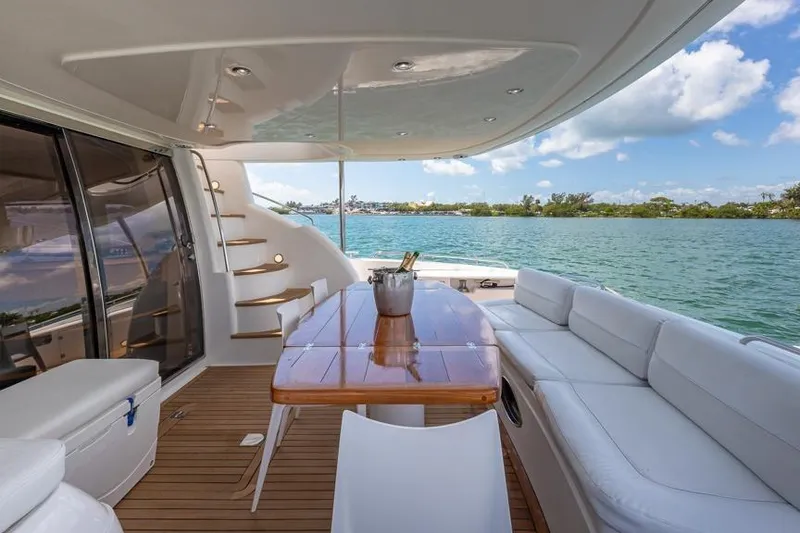 Slide: The Image of Luxurious Sunseeker Manhattan 74 yacht deck with elegant seating, table, and ocean view. - 27
