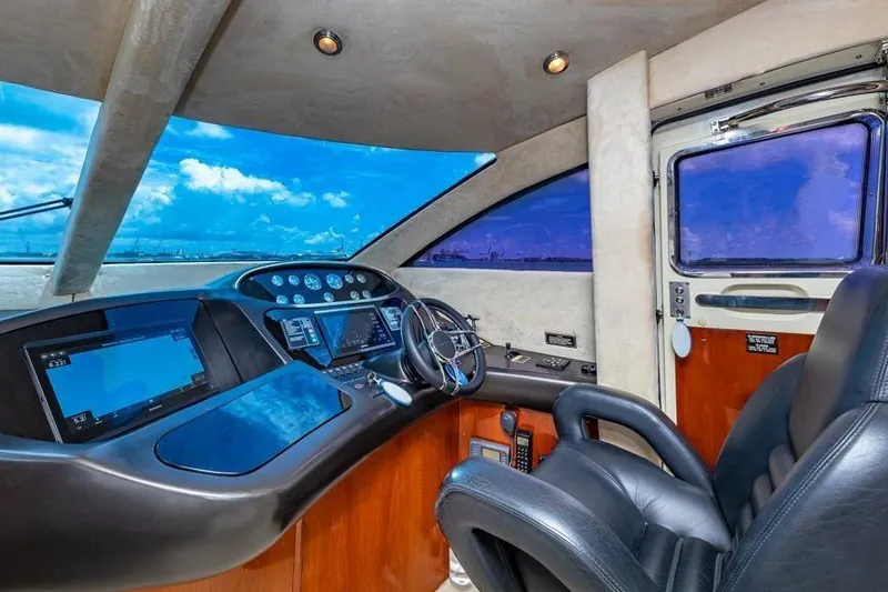 Slide: The Image of Luxurious helm of 2000 Sunseeker Manhattan 74 yacht with modern controls and leather seating. - 34