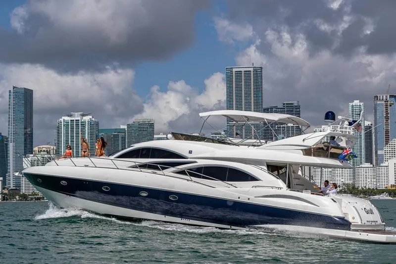 Slide: The Image of Sunseeker Manhattan 74 yacht cruising near city skyline, 2000 model. - 40