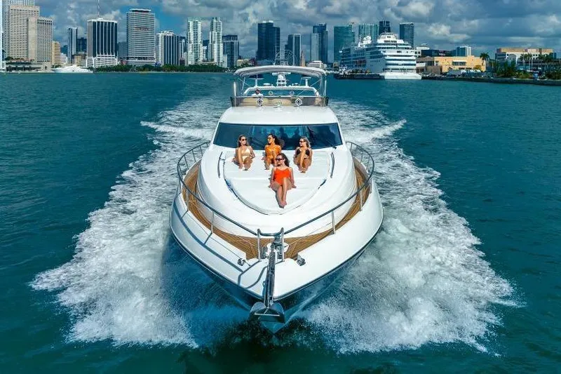 Slide: The Image of Luxury Sunseeker Manhattan 74 yacht cruising near city skyline, 2000 model. - 8