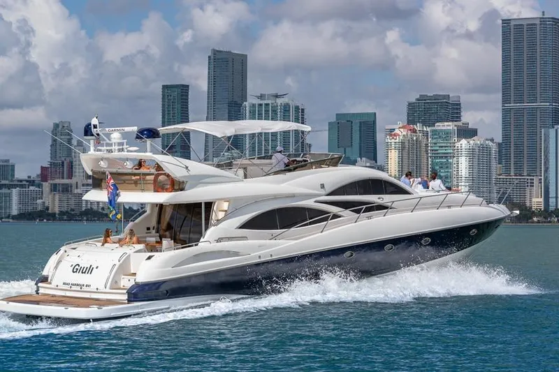 Slide: The Image of Sunseeker Manhattan 74 yacht cruising near city skyline, 2000 model. - 9
