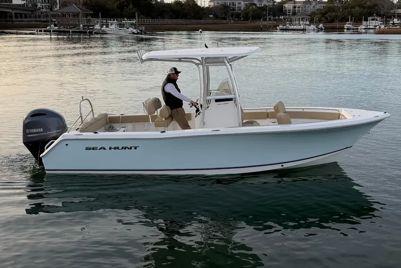 Slide: The Image of 2014 Sea Hunt Ultra 225 boat on calm water with Yamaha engine. - 10