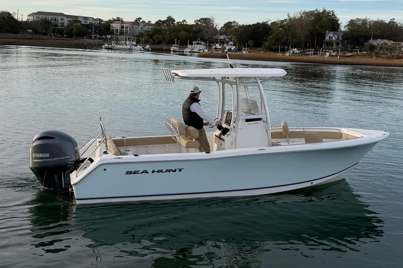 Slide: The Image of 2014 Sea Hunt Ultra 225 boat on calm water with Yamaha engine. - 11