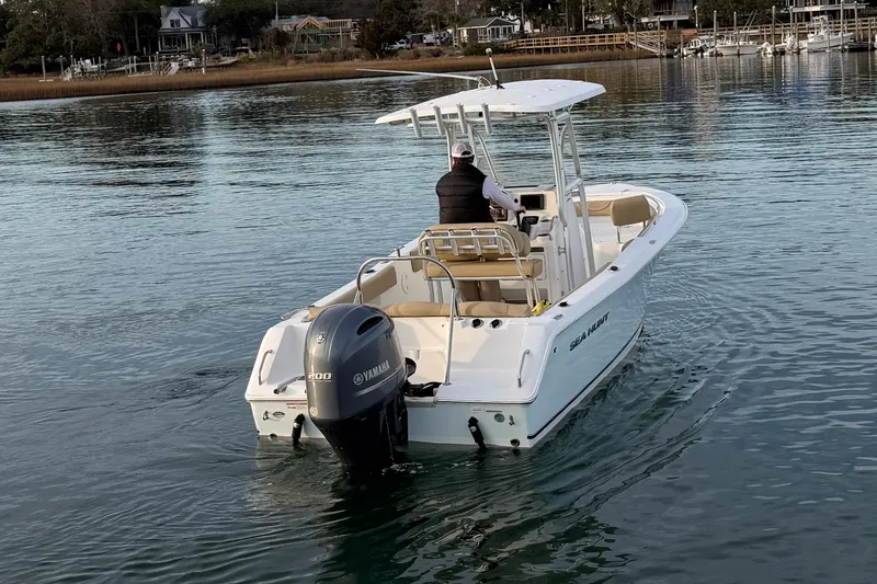 Slide: The Image of 2014 Sea Hunt Ultra 225 boat on calm water, rear view with Yamaha engine. - 12