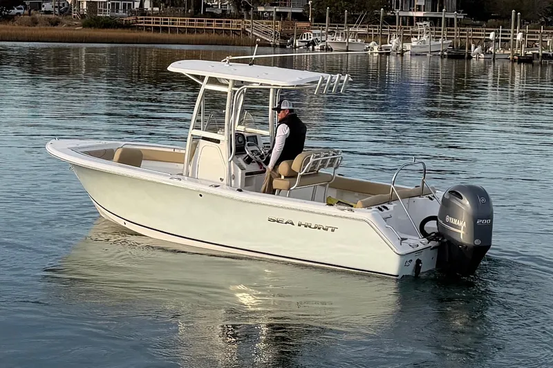 Slide: The Image of 2014 Sea Hunt Ultra 225 boat on calm water with Yamaha engine. - 14