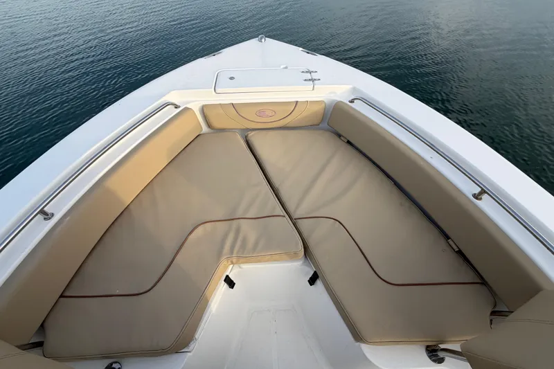 Slide: The Image of Bow seating area of a 2014 Sea Hunt Ultra 225 boat on calm water. - 20