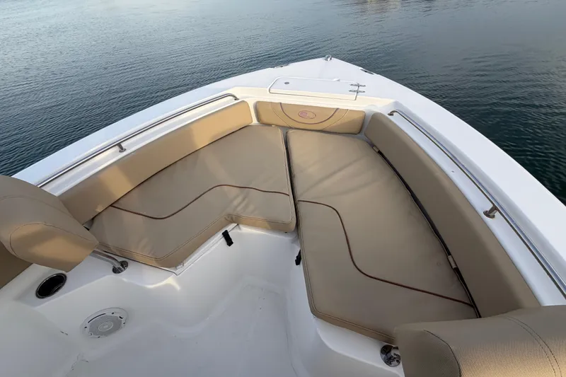 Slide: The Image of 2014 Sea Hunt Ultra 225 boat with beige seating, on calm water. - 22