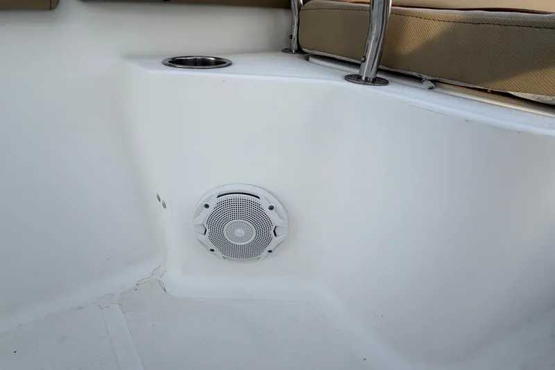 Slide: The Image of 2014 Sea Hunt Ultra 225 boat interior with speaker and cup holder. - 28