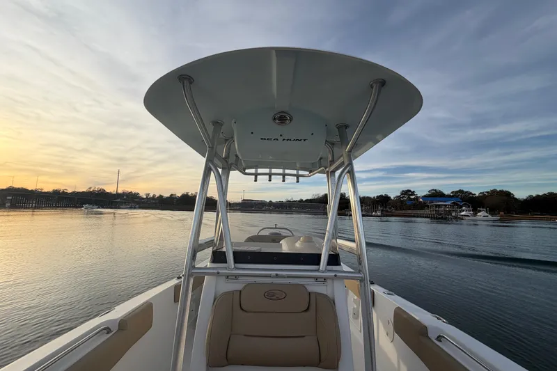 Slide: The Image of 2014 Sea Hunt Ultra 225 boat on calm water at sunset. - 31