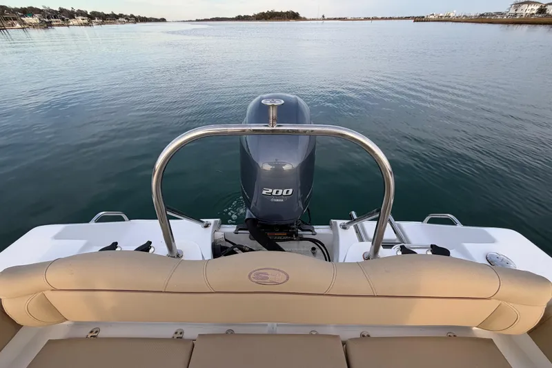 Slide: The Image of 2014 Sea Hunt Ultra 225 boat with Yamaha 200 engine on calm water. - 40