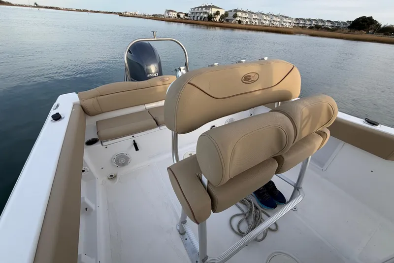 Slide: The Image of 2014 Sea Hunt Ultra 225 boat interior with beige seating and Yamaha 200 engine. - 42