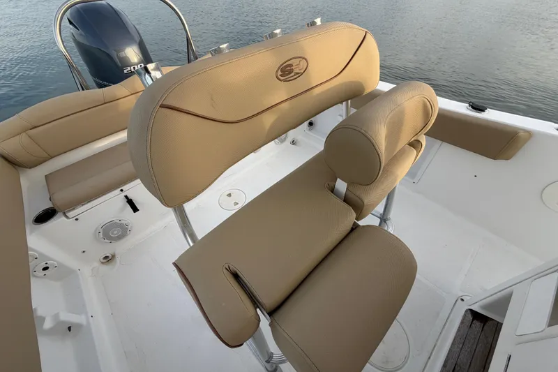 Slide: The Image of 2014 Sea Hunt Ultra 225 boat interior with tan seating and Yamaha 200 engine. - 43