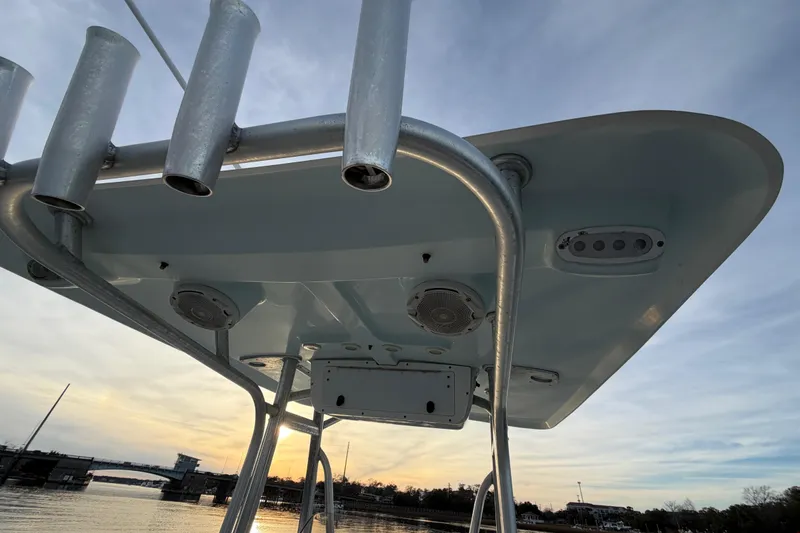 Slide: The Image of 2014 Sea Hunt Ultra 225 boat top view with rod holders at sunset. - 44