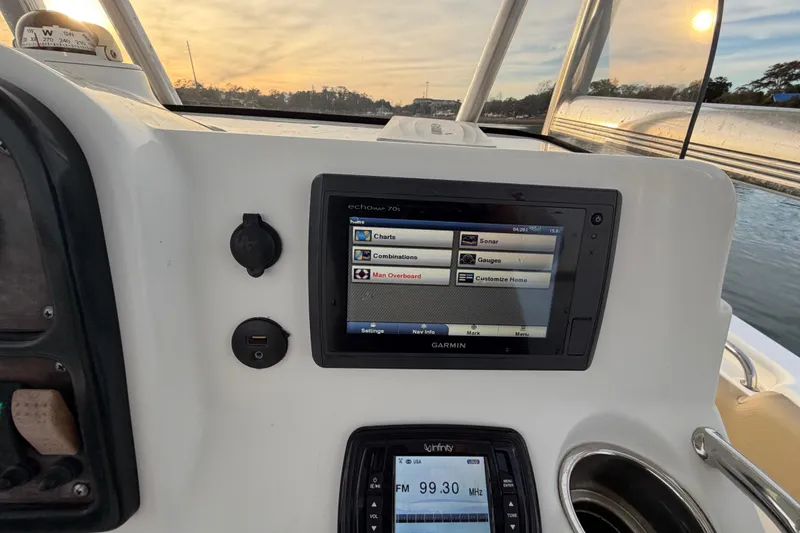 Slide: The Image of 2014 Sea Hunt Ultra 225 dashboard with Garmin navigation system at sunset. - 46