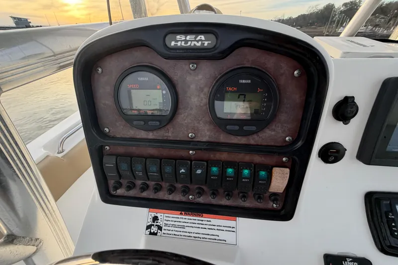 Slide: The Image of Dashboard of 2014 Sea Hunt Ultra 225 boat with Yamaha gauges at sunset. - 47