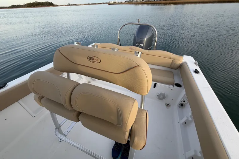 Slide: The Image of 2014 Sea Hunt Ultra 225 boat interior with tan seating and Yamaha 200 engine. - 48