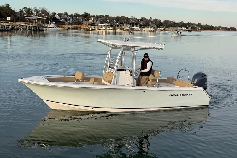 Slide: The Image of 2014 Sea Hunt Ultra 225 boat on calm water, featuring sleek design and modern amenities. - 8