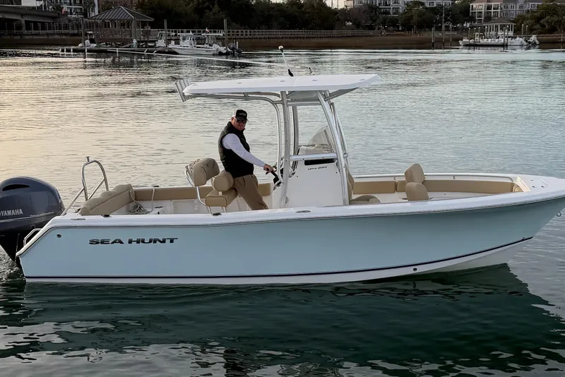 Slide: The Image of 2014 Sea Hunt Ultra 225 boat on calm water with a Yamaha engine. - 9