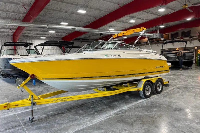 The Image of Yellow 2006 Monterey 234FS boat on trailer in indoor showroom. - 1