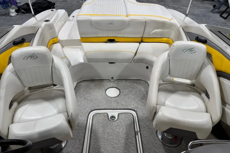 Slide: The Image of Interior of a 2006 Monterey 234FS boat with white and yellow seating. - 16