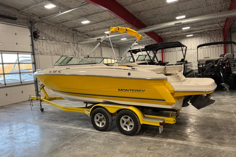 Slide: The Image of Yellow 2006 Monterey 234FS boat on trailer in indoor storage facility. - 3