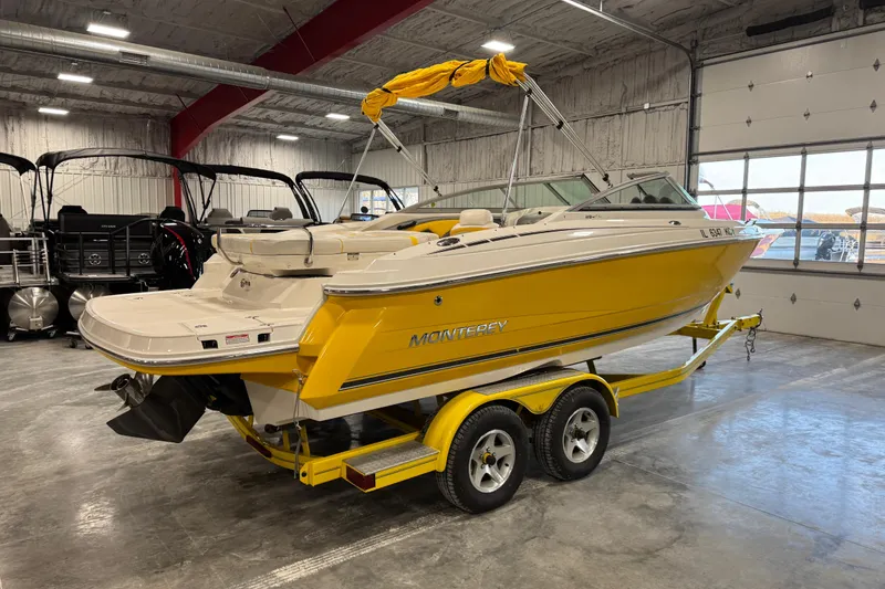 Slide: The Image of Yellow 2006 Monterey 234FS boat on trailer in indoor showroom. - 4