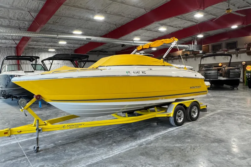 Slide: The Image of Yellow 2006 Monterey 234FS boat on trailer in indoor showroom. - 5