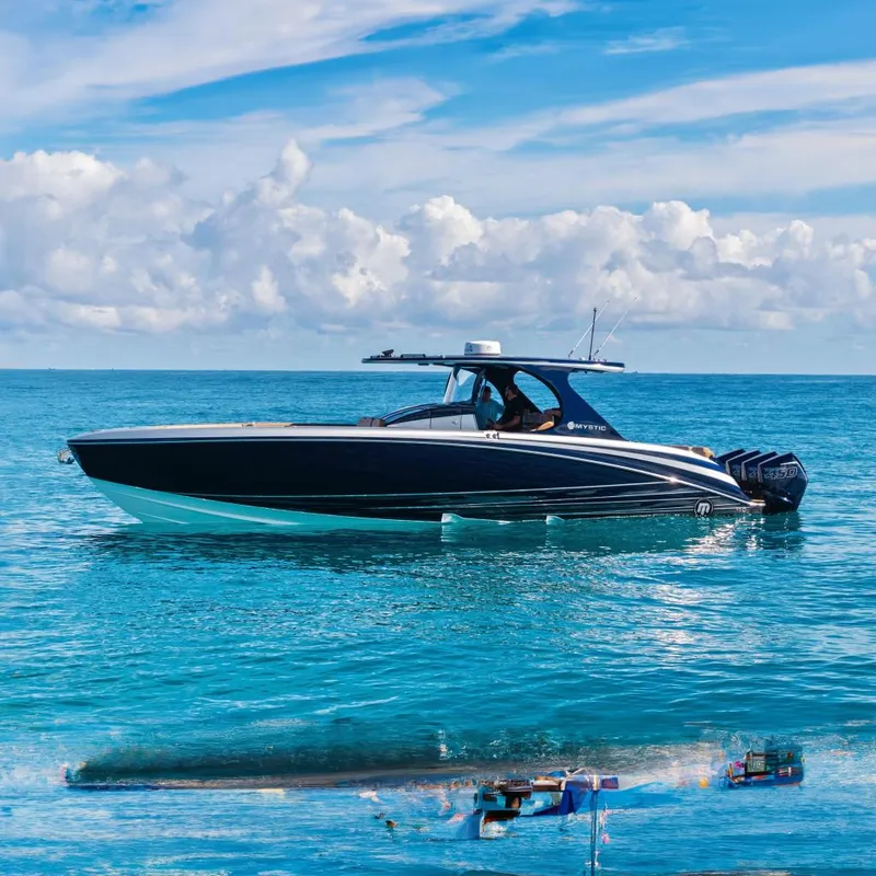 The Image of 2021 Mystic Powerboats M4200 on clear blue ocean under cloudy sky. - 0