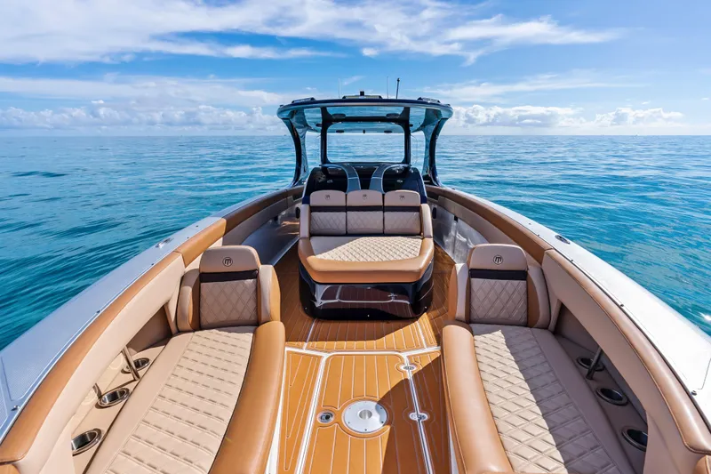 Slide: The Image of 2021 Mystic Powerboats M4200 luxury interior on open water, featuring elegant seating and design. - 14