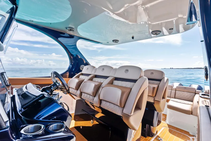 Slide: The Image of 2021 Mystic Powerboats M4200 interior with luxurious seating and ocean view. - 16