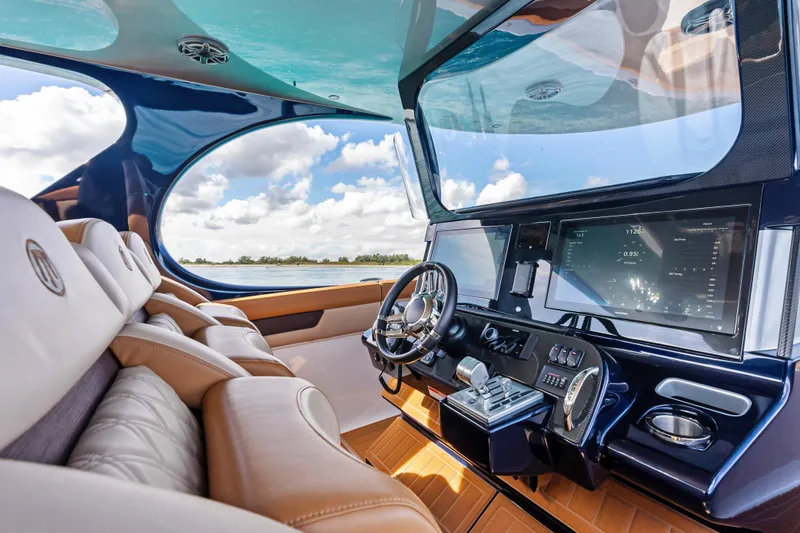 Slide: The Image of Luxurious 2021 Mystic Powerboats M4200 cockpit with advanced navigation system and plush seating. - 17