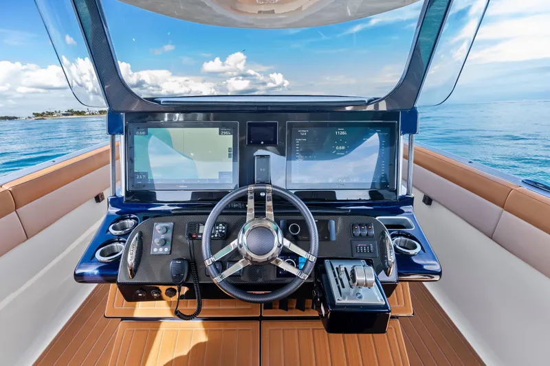 Slide: The Image of Cockpit of 2021 Mystic Powerboats M4200 with advanced navigation displays and steering wheel. - 18