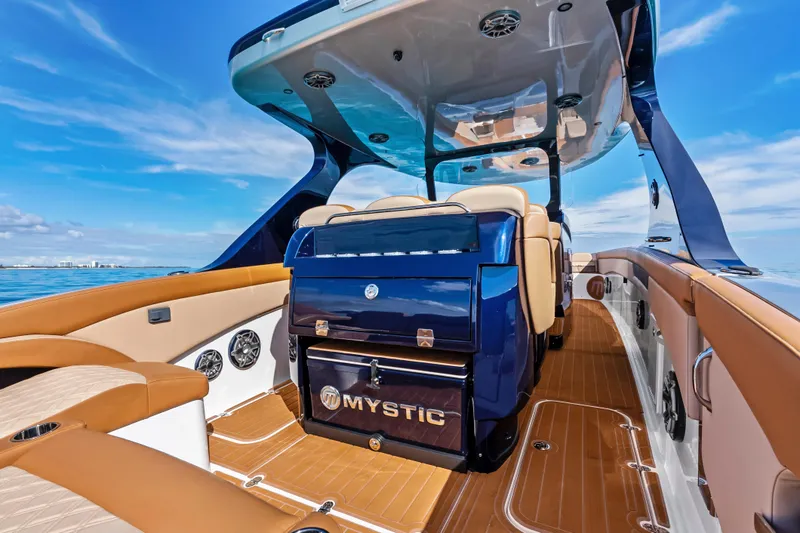 Slide: The Image of 2021 Mystic Powerboats M4200 interior with luxurious seating and sleek design on open water. - 23