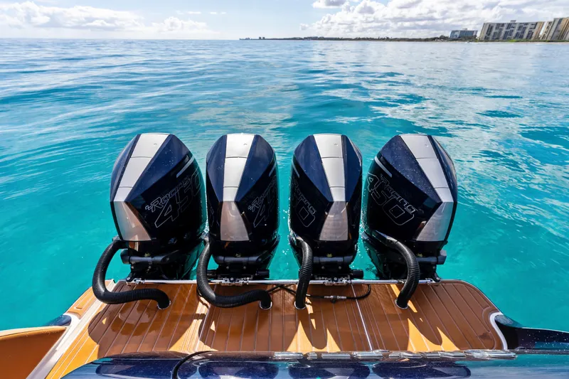 Slide: The Image of 2021 Mystic Powerboats M4200 with four powerful outboard engines on clear blue water. - 24